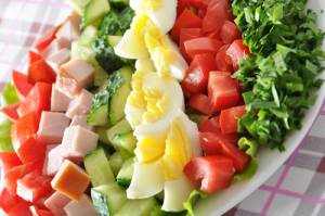 Fresh salad with chicken breast,lettuce, eggs and tomatoes