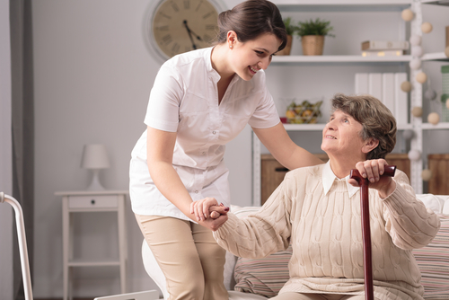 caregiver supporting elderly woman