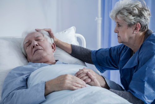 wife comforting elderly husband