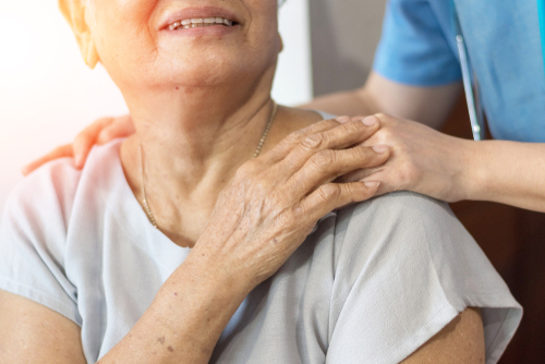 caregiver holding patient hand