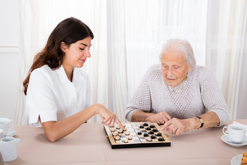 senior woman playing checkers