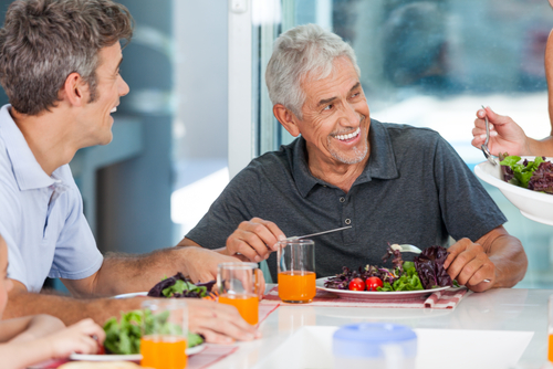 senior man with family for dinner