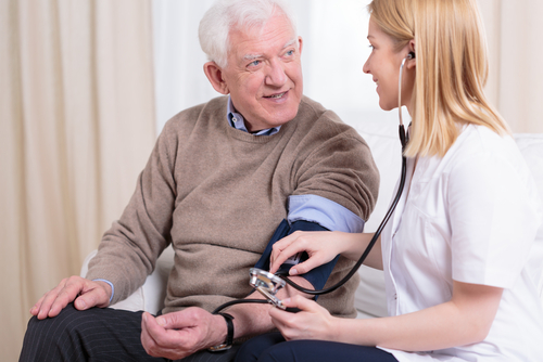 caregiver checking patient hypertension