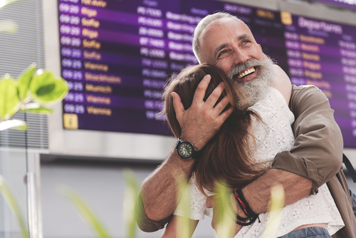 senior man with child at airport