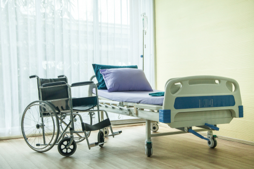 wheelchair and hospital bed near window