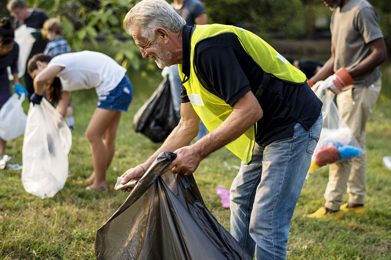 group of people cleaning the park