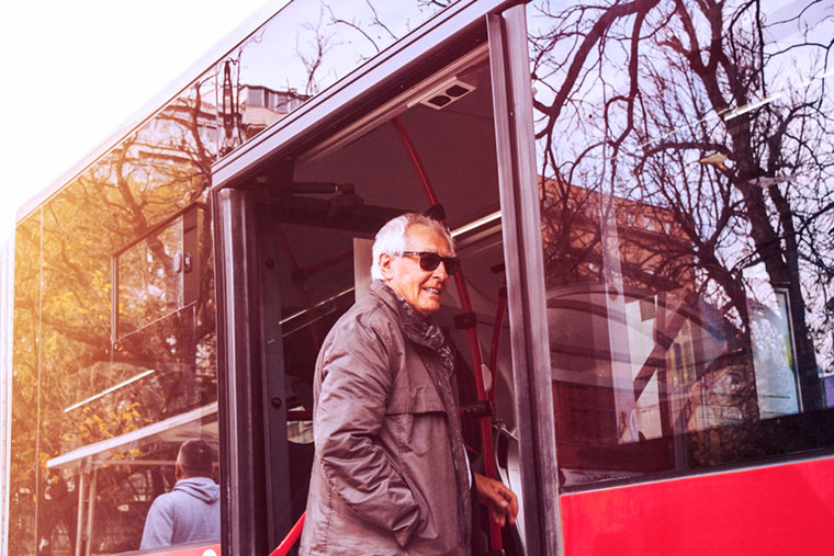 senior man entering the bus